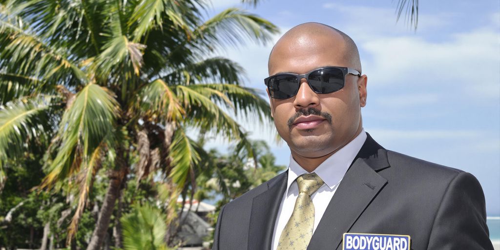 Bodyguard in Bali with tropical beach background.